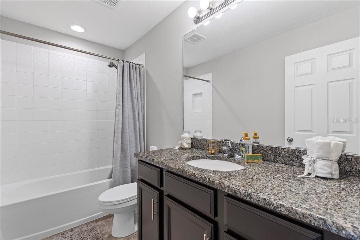 Full guest bath with modern finishes and ample storage