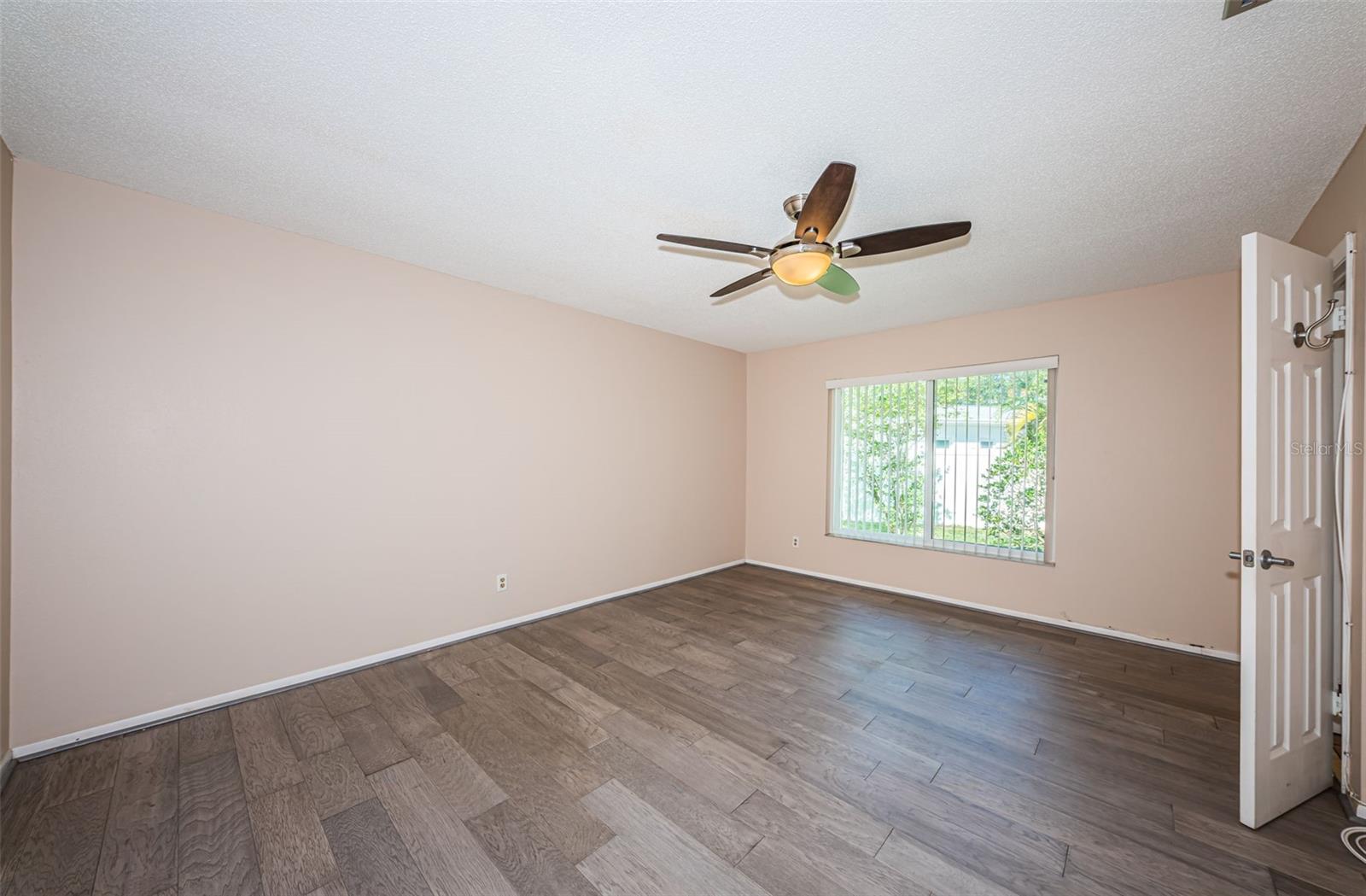 Primary bedroom with engineered hardwood flooring