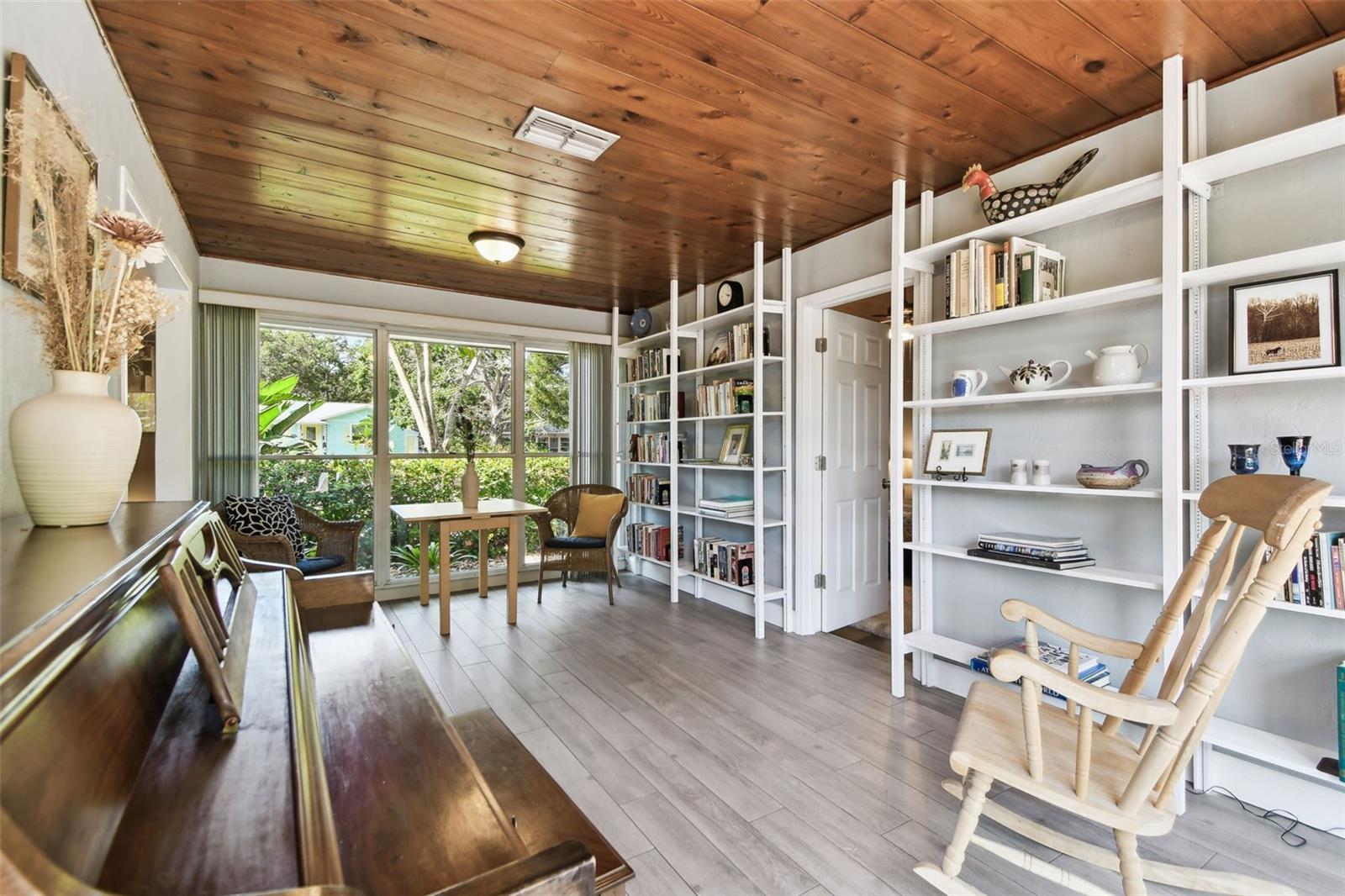 Built in shelving for artwork or fun reading. Sunny windows with a view to the big backyard.