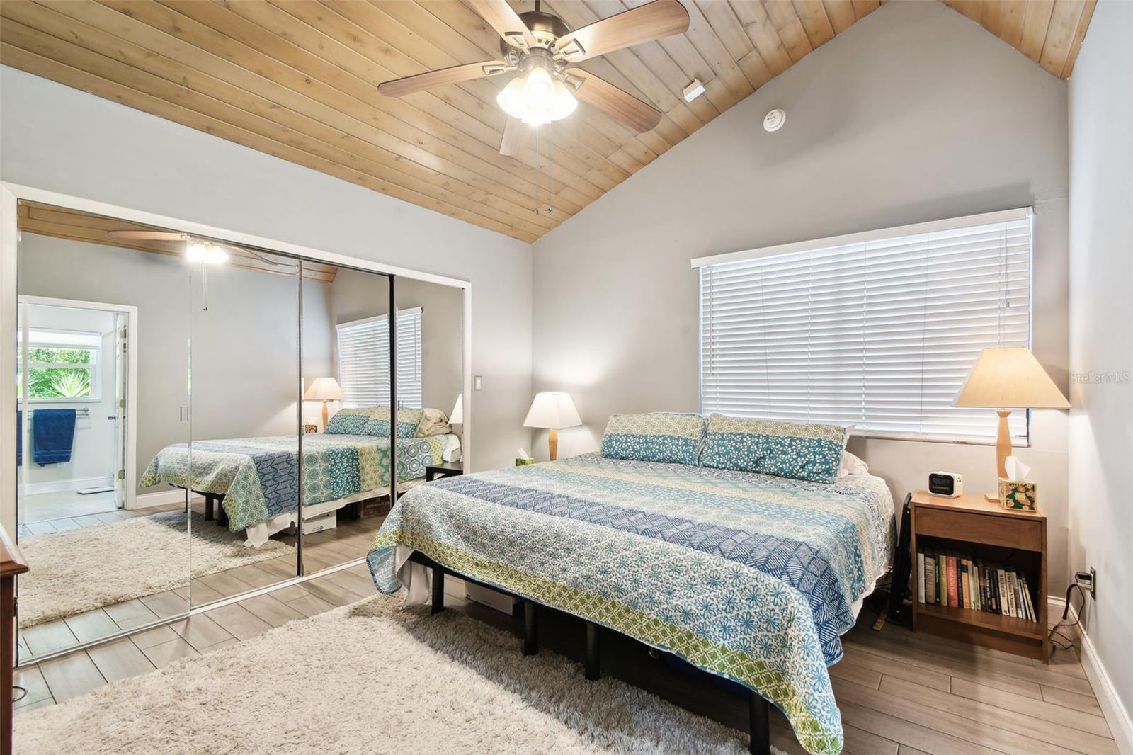 Master Bedroom with lots of closet space, high ceiling, fan and nice light.