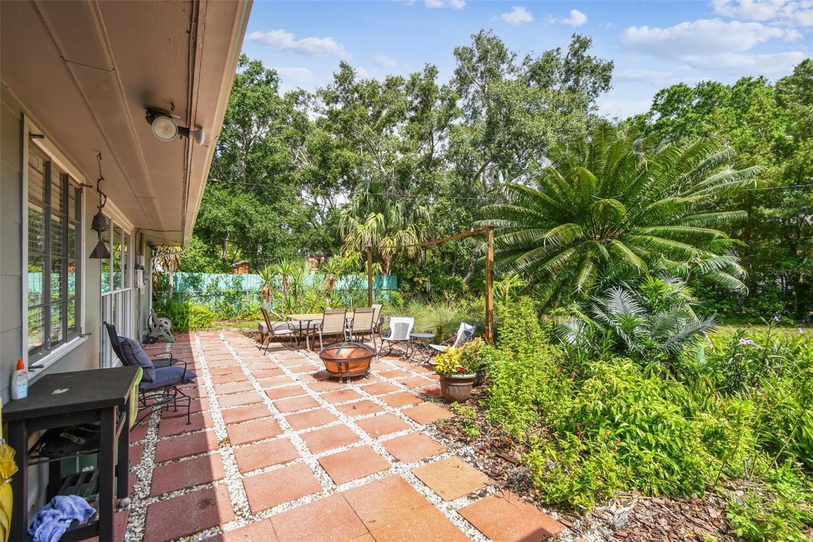 Room for a firepit, and table for outdoor dining. Lush garden surrounding you