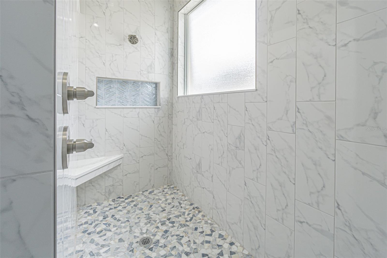 En suite Bath with walk in shower with bench