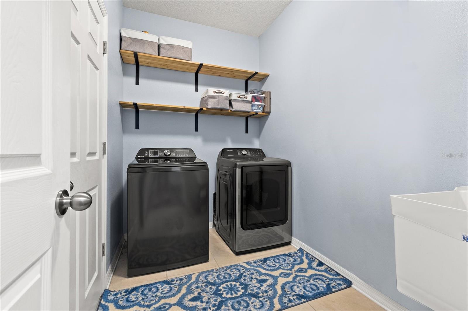 Large laundry room with utility sink