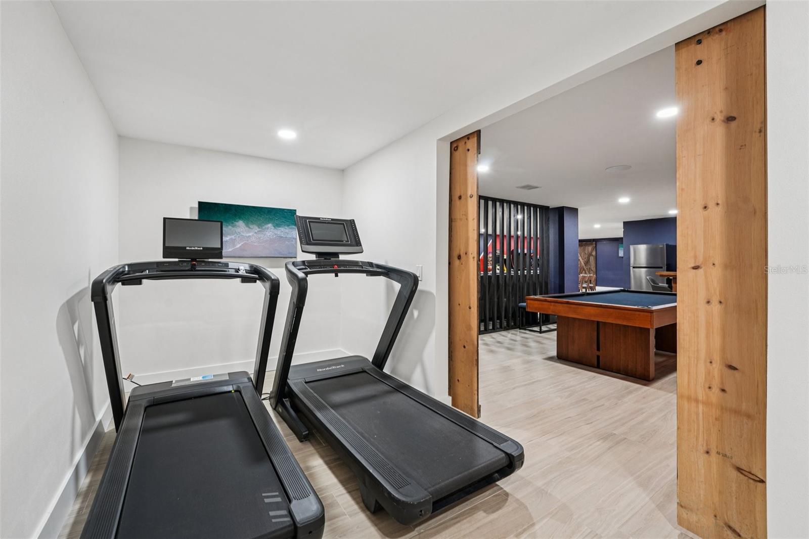 Separate workout room with barn doors