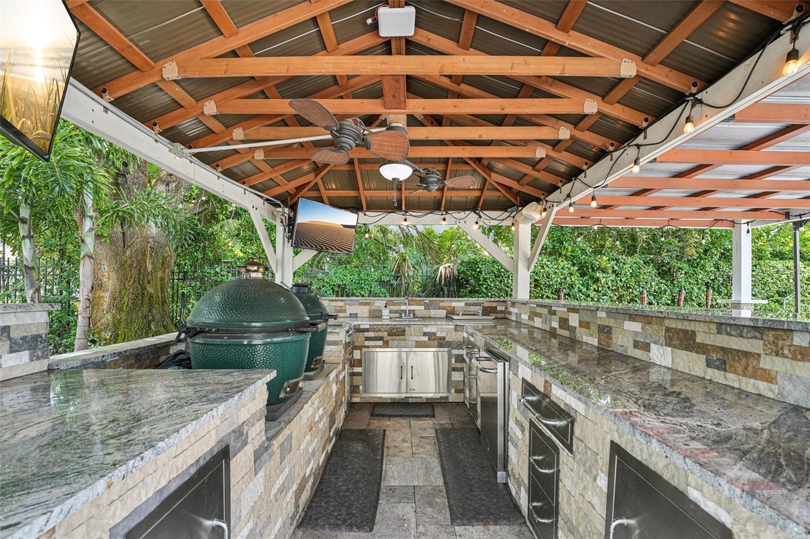 Covered large outdoor kitchen with granite counters, Grill and Green Egg