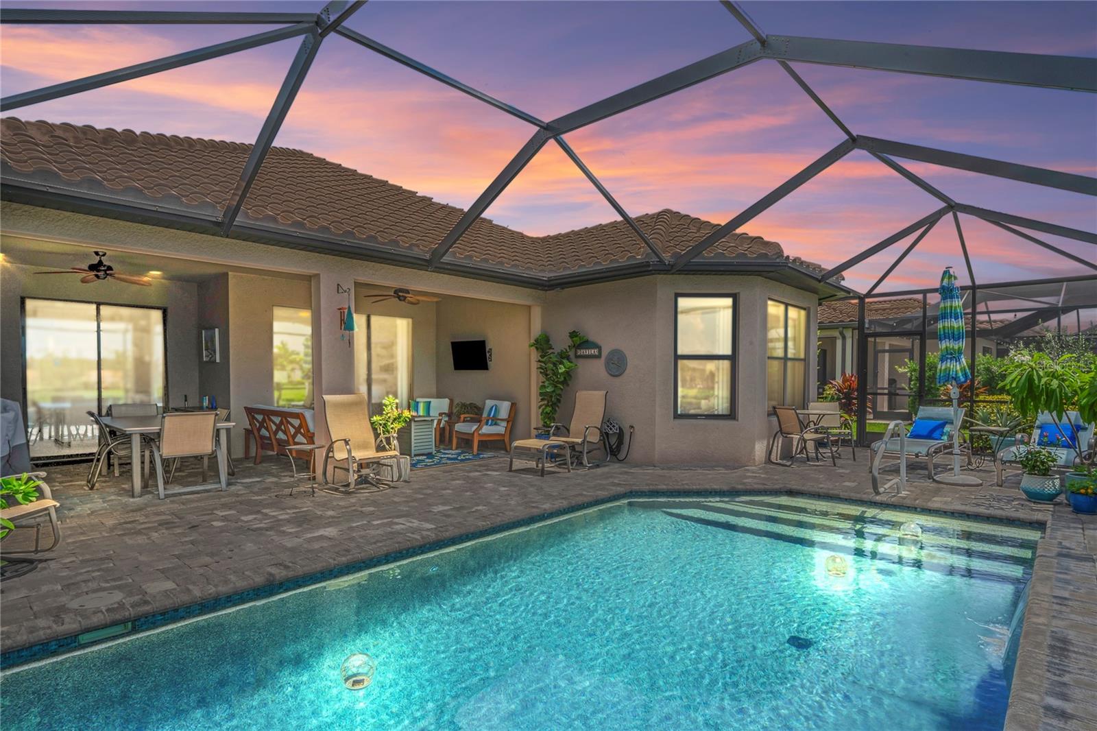 Dusk view of pool from rear side angle