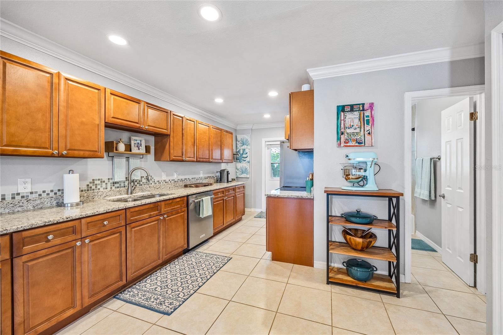 This beautifully updated kitchen features rich wood cabinetry, granite countertops, stainless appliances, and loads of prep space—perfect for the home chef.