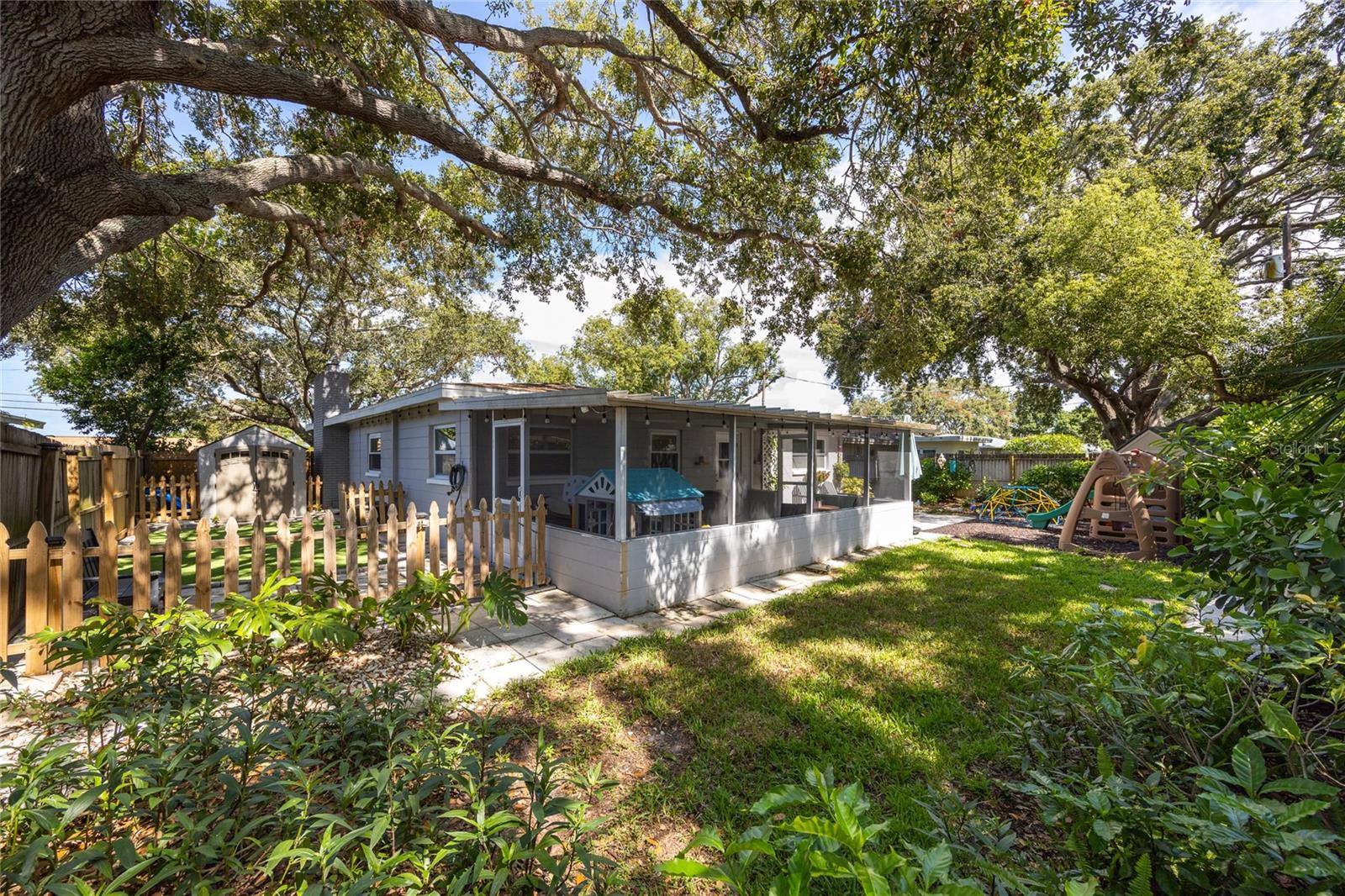 Lush and private—this yard is built for barbecues, gardening, and Florida living.