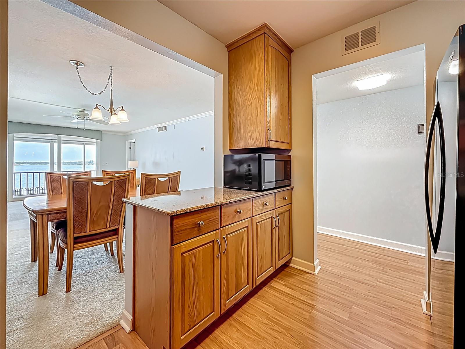 This shows your breakfast bar or island that opens the kitchen into the dining room and offers such nice views looking out to the water.