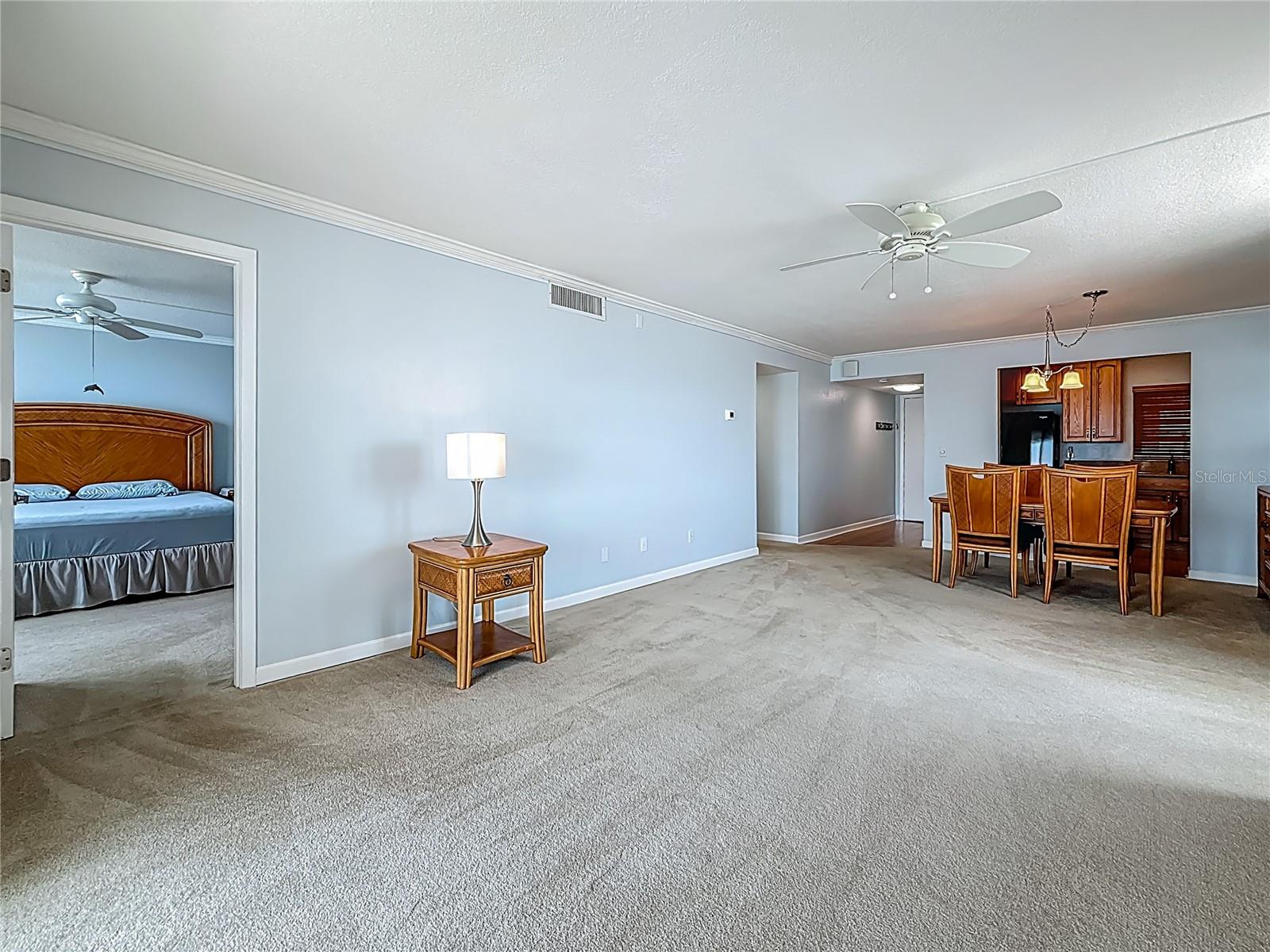 This picture shows the door into the primary bedroom and helps to show that this condo offers a split bedroom plan.  The other 2 bedrooms are to the left of the dining room in this picture.