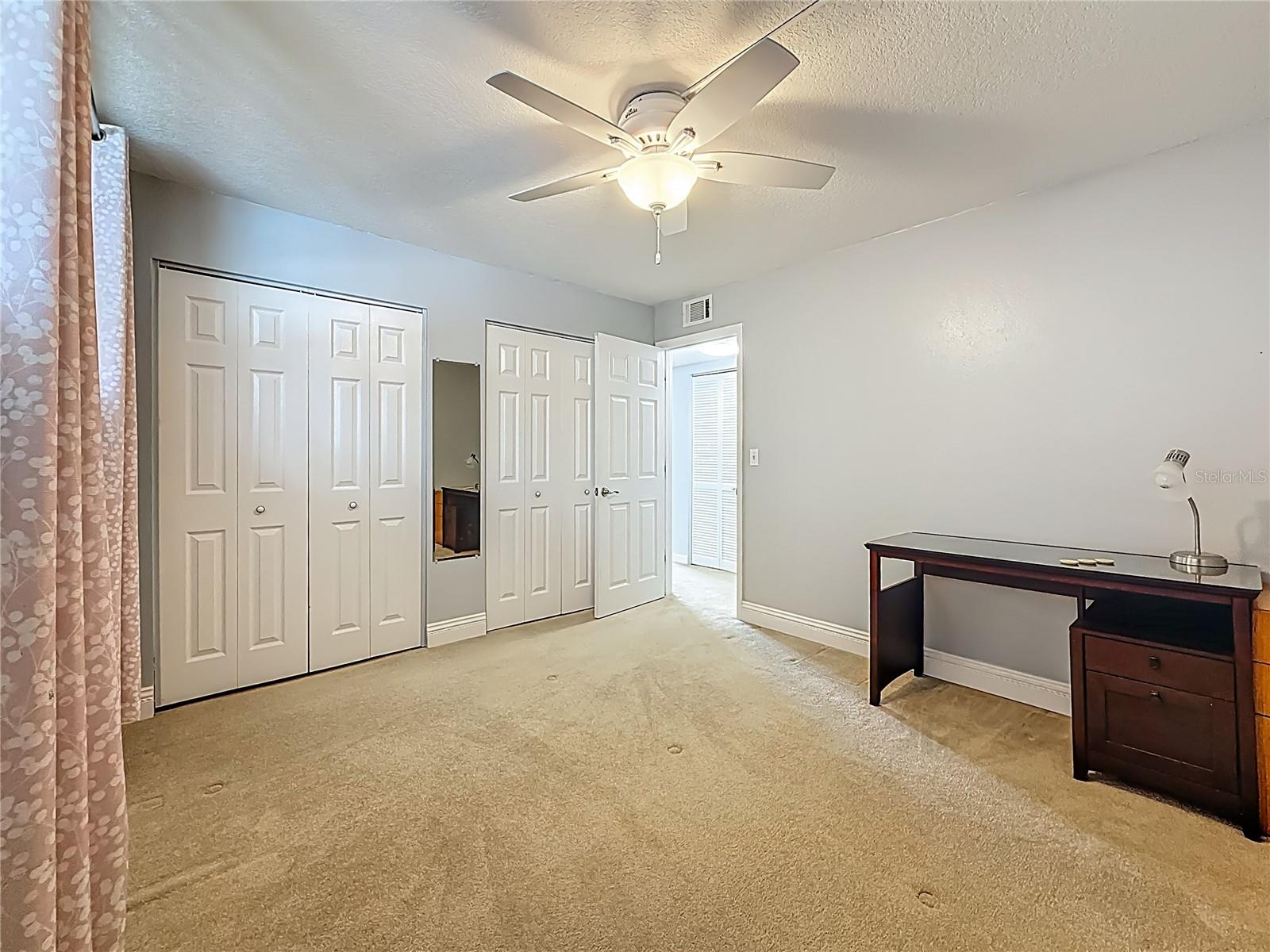 Another guest bedroom that is spacious with lots of closet space.