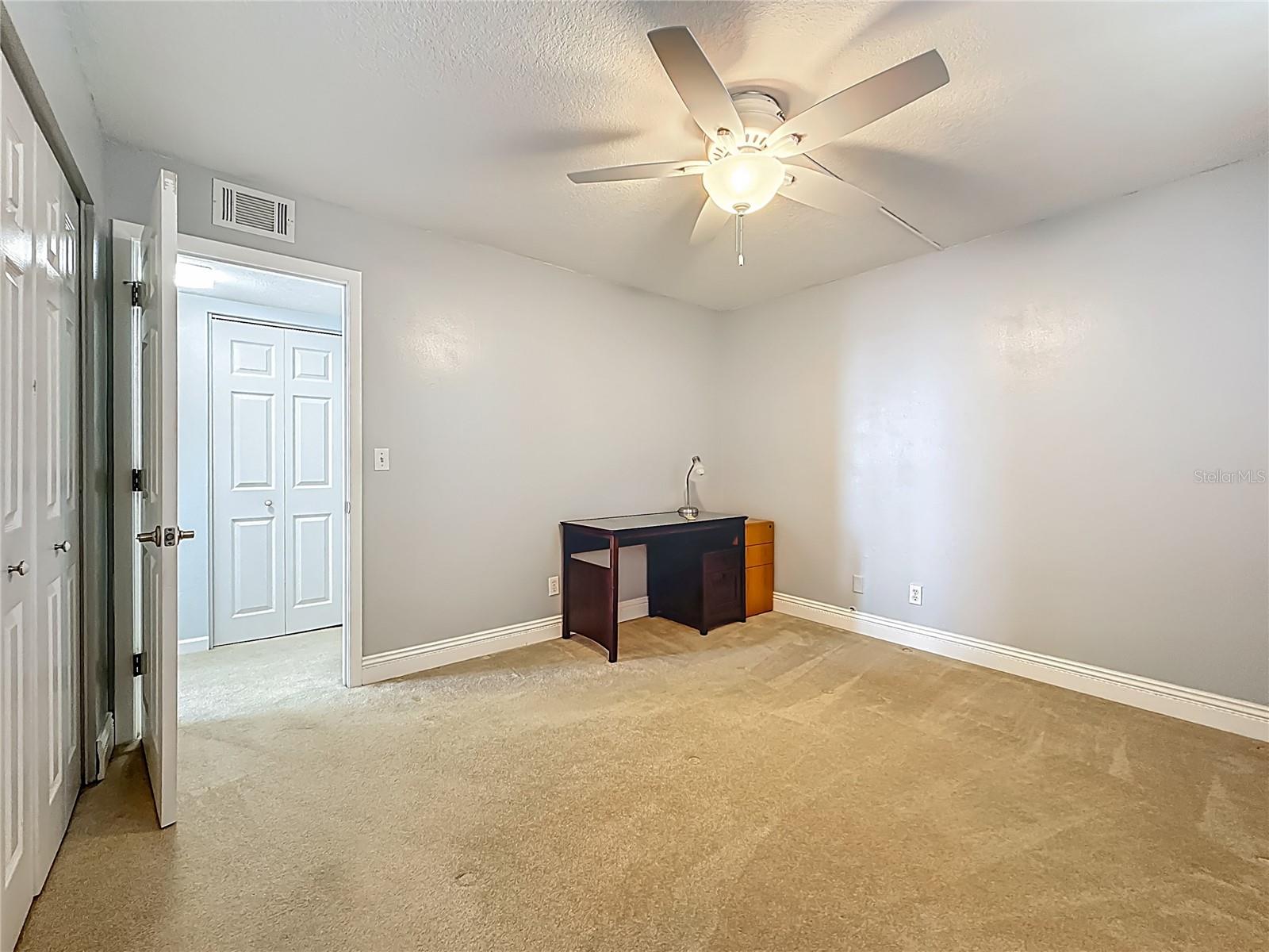 Closer look at how spacious this guest bedroom is.