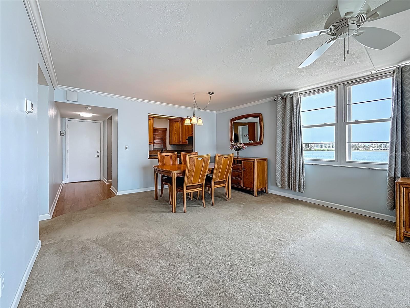 This picture looks from your sliders on your back balcony into the living and dining area and kitchen.  Notice the extra windows since this is a corner unit that offers an abundance of extra light and also extra water views.