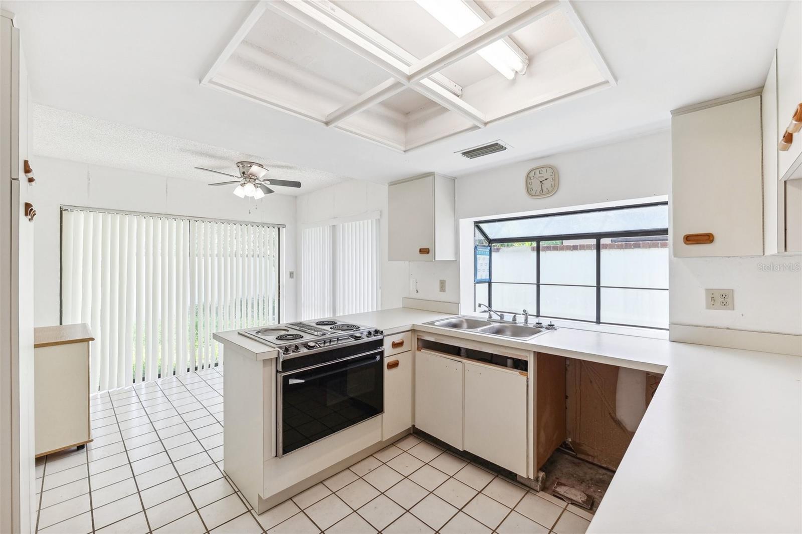 Kitchen area with bay window looking out to side yard.