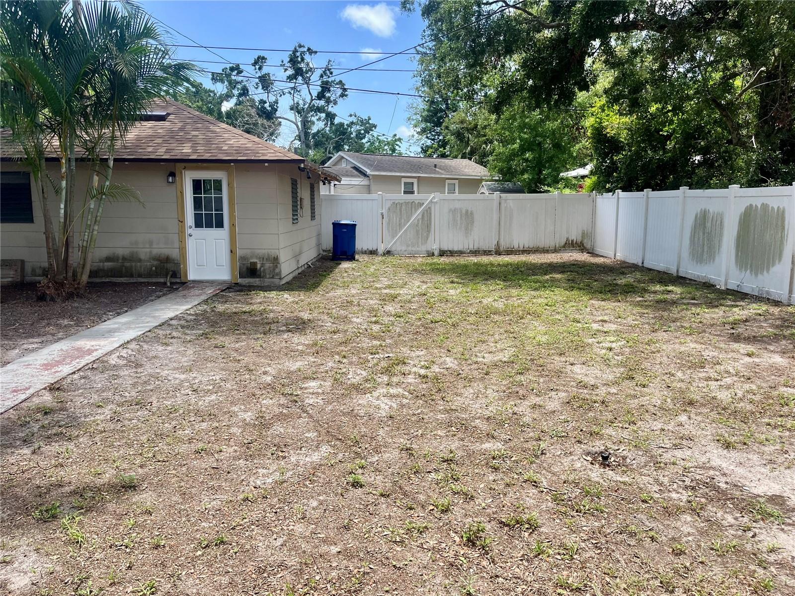 Detached 2 car garage with alley access and oversized PVC fenced yard.