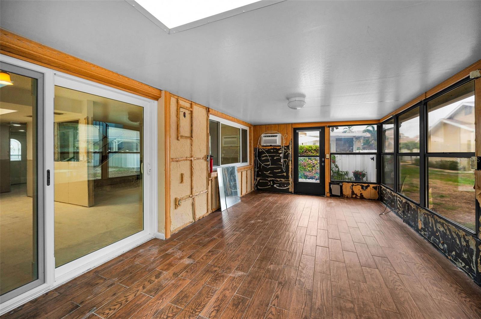 Sunroom leads to private backyard patio.