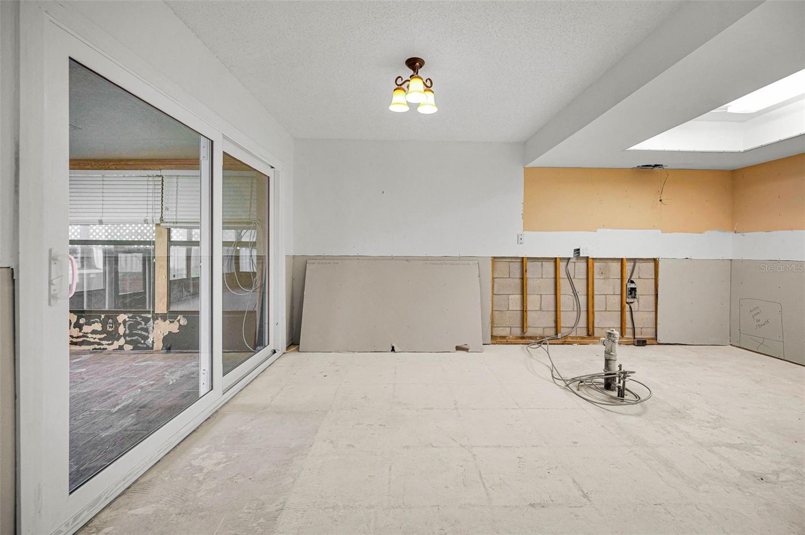 Kitchen leads to airconditioned sunroom through newer impact sliders.