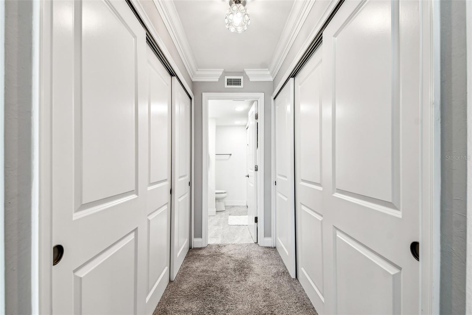 Primary Bedroom Hallway to Dual Closet & En Suite Bath