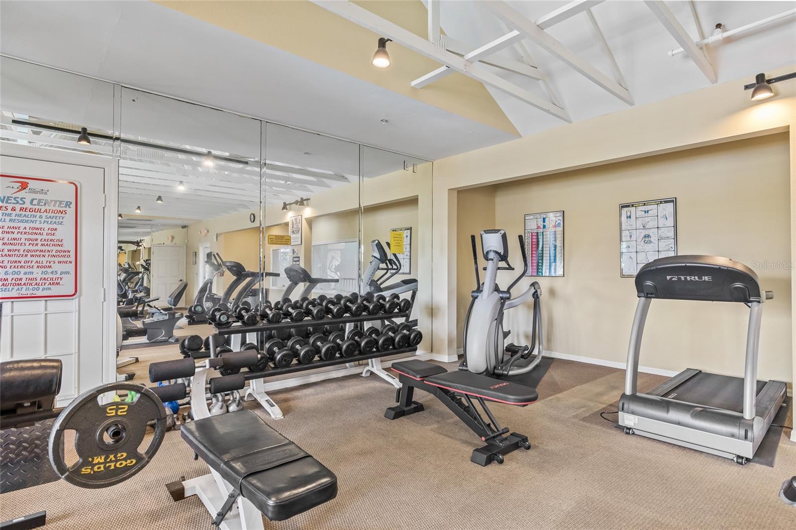 Fitness Center with Free Weights. On-site fitness center includes cardio machines, free weights, and strength equipment for a full-body workout.