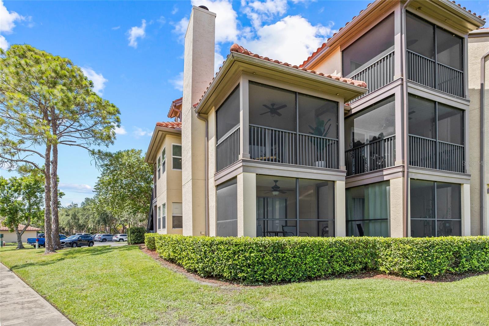 Charming Mediterranean-Style Architecture. The building features classic tile roofing, screened balconies, and well-maintained landscaping for timeless curb appeal. 2nd floor corner lanai is yours!