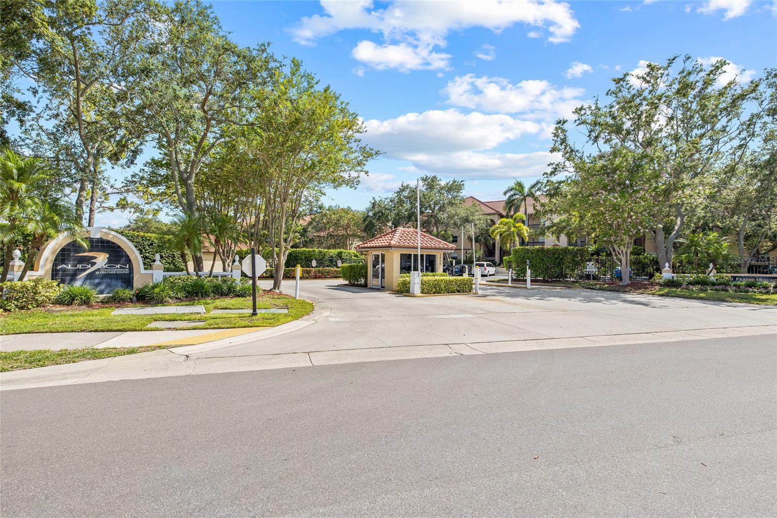 A warm welcome home—this secure, gated entrance sets the tone for the resort-style living and sense of community found within Audubon Condominiums at Feather Sound.