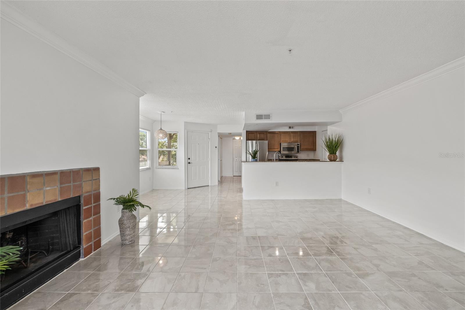 Versatile Living and Entertaining Space. Bright, open-concept floor plan with gleaming tile floors and plenty of room to personalize.