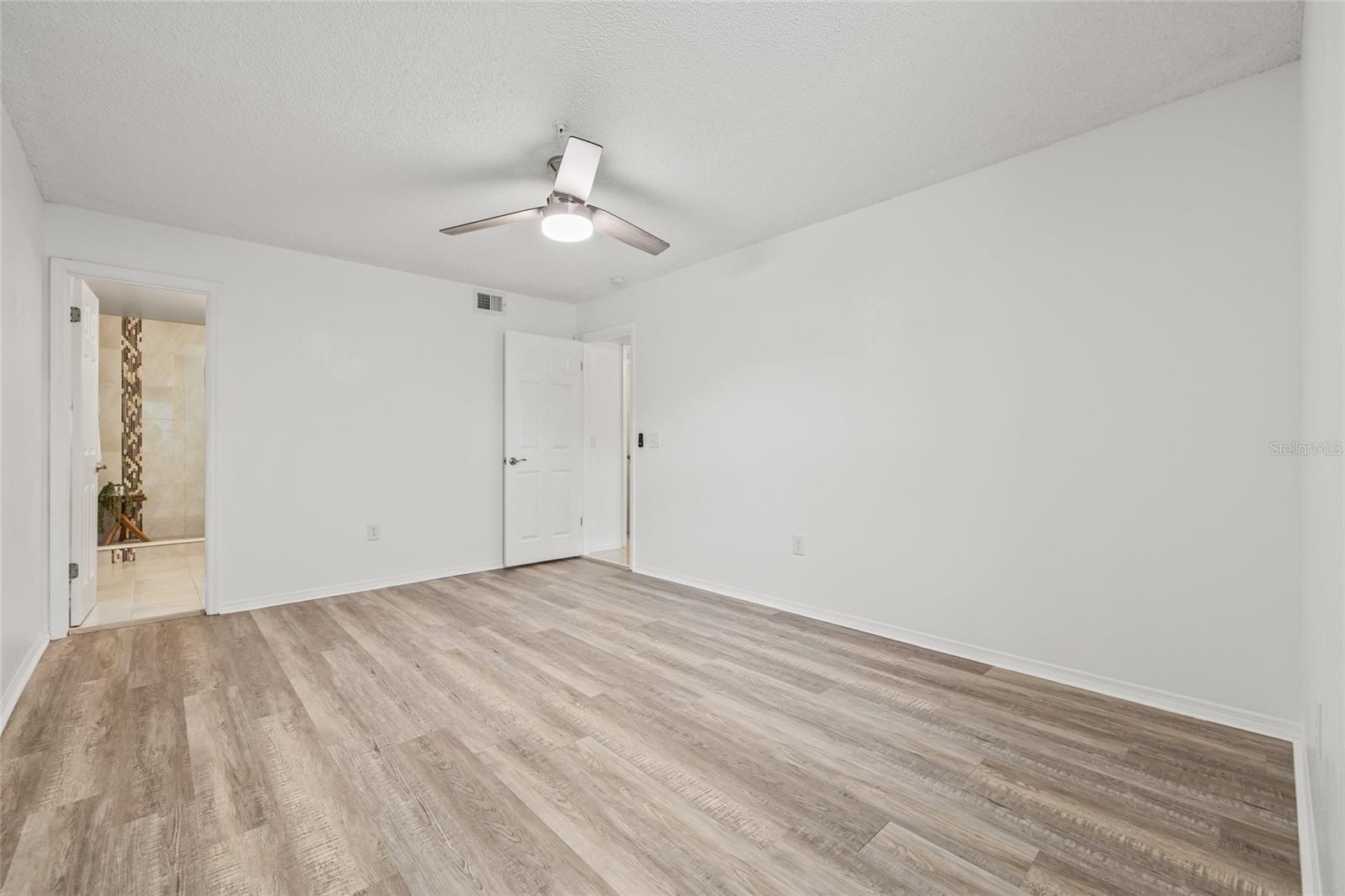 Primary Bedroom with Ensuite. Direct access to a stylish ensuite bathroom and walk-in closet adds convenience and comfort.