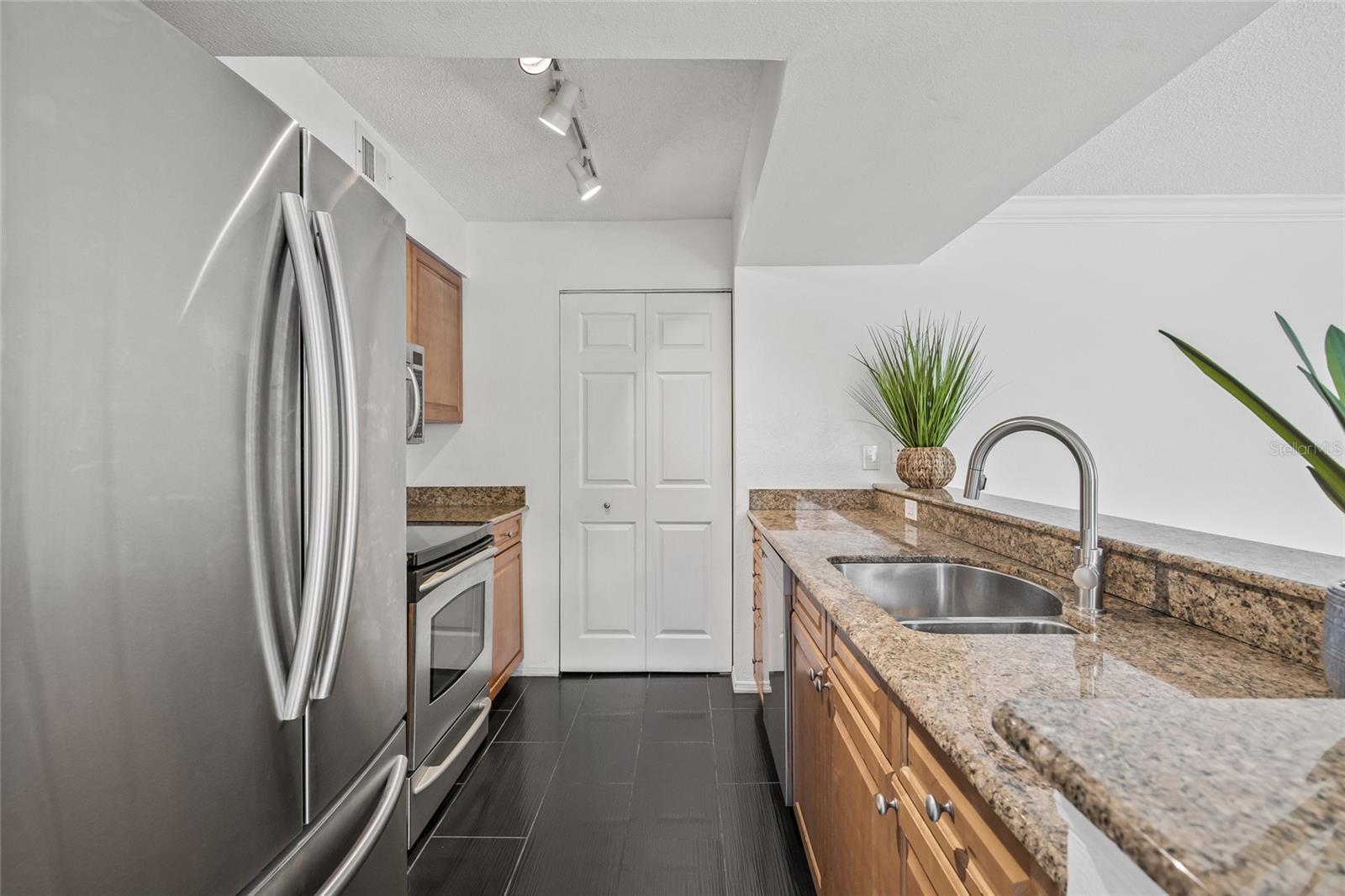 Stylish and Functional Kitchen. Granite countertops, stainless steel appliances, and wood cabinetry make this kitchen perfect for cooking and entertaining.