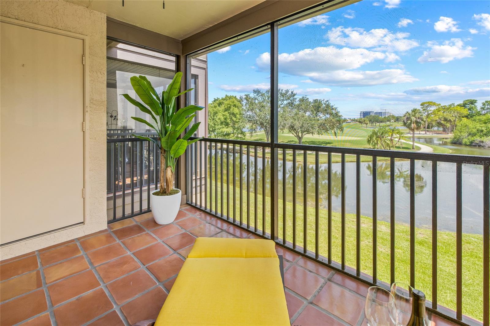 Tranquil Screened-In Retreat. Enjoy panoramic vistas of the golf course and water from this peaceful and private top-floor lanai.