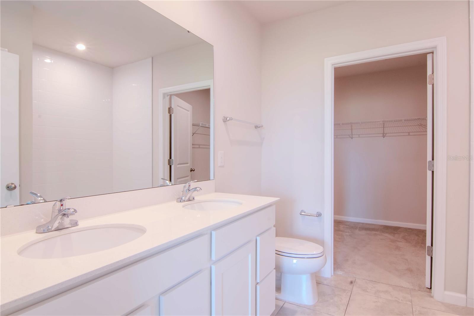 This spacious primary bath offers dual sinks!