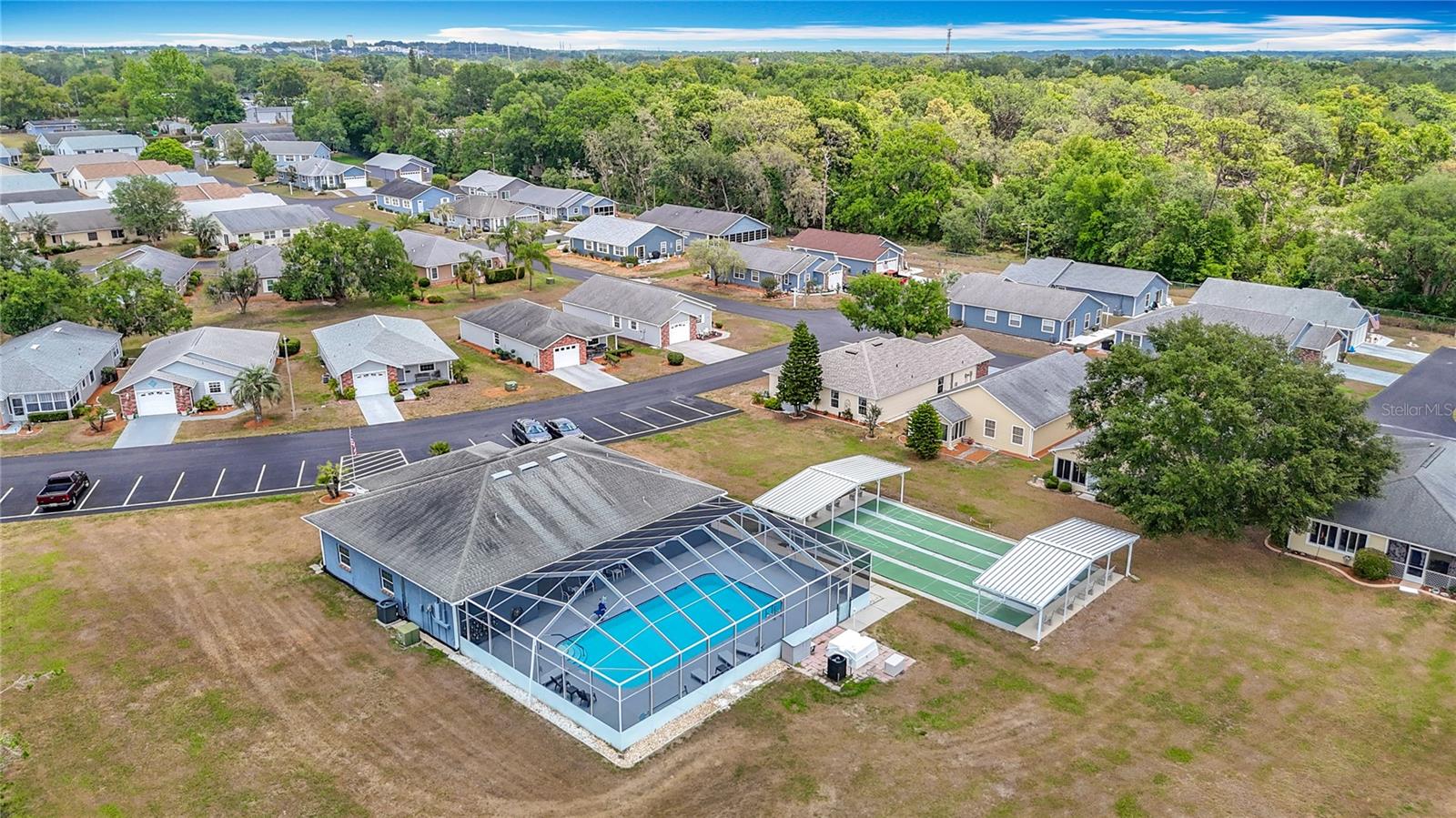 Aerial view of house, clubhouse, pool