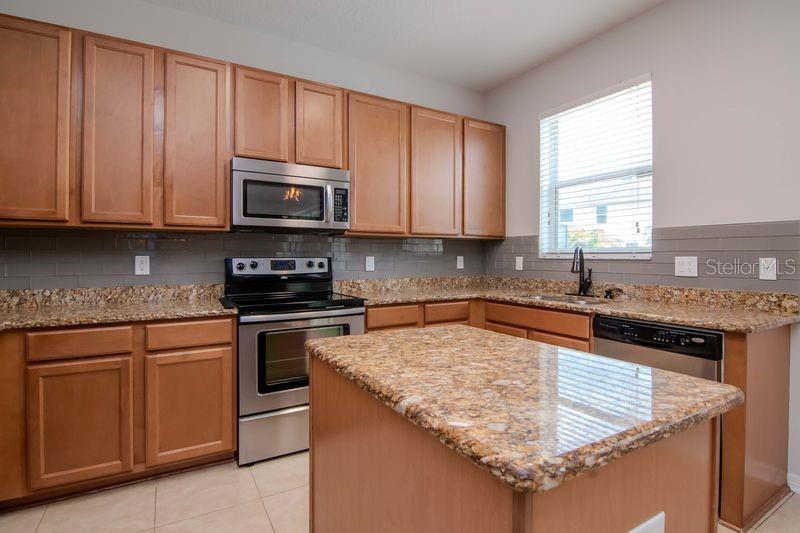Granite Countertops and 42" honey maple cabinets.