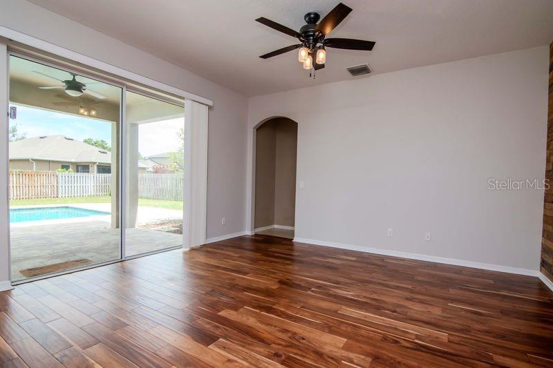 Family Room opens to Covered Lanai and Backyard.