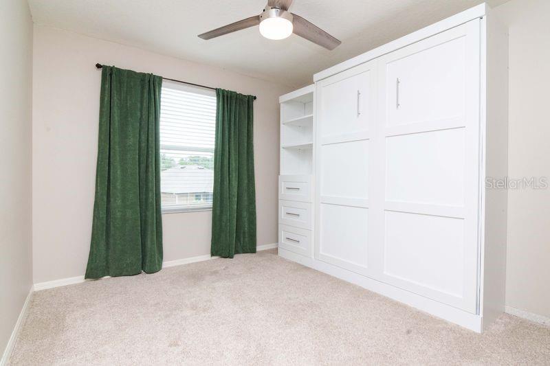 3rd Bedroom with built-in Murphy Bed with extra shelving and storage.