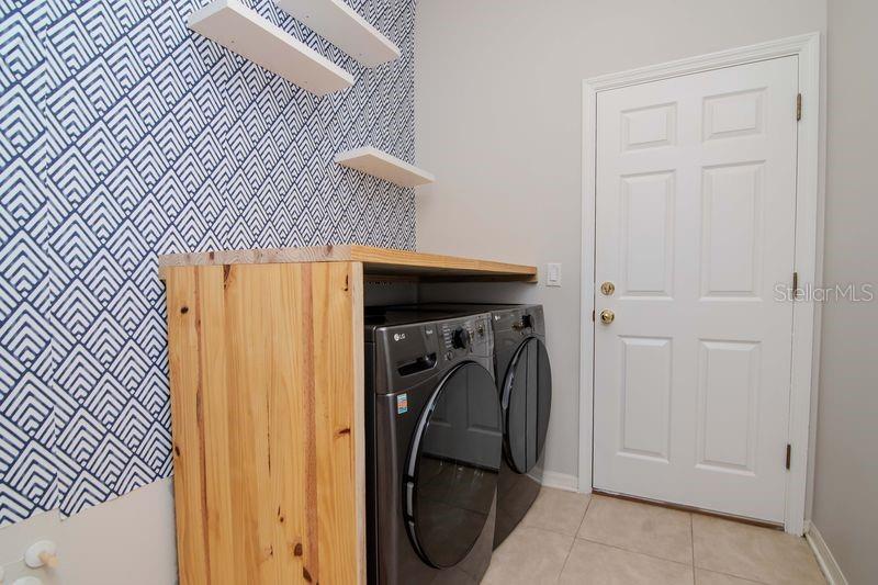 Laundry Room with front load washer and Dryer, pre-plumbed for a sink.