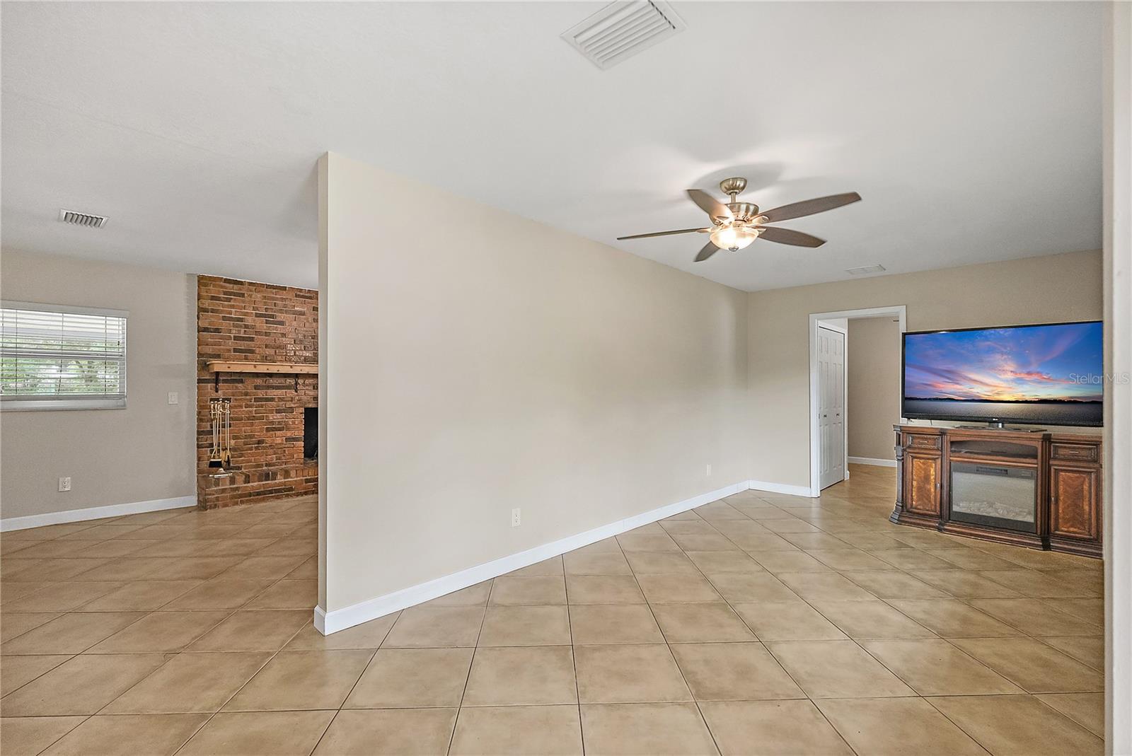 Living Room flows to the Family Room, Fireplace and Kitchen