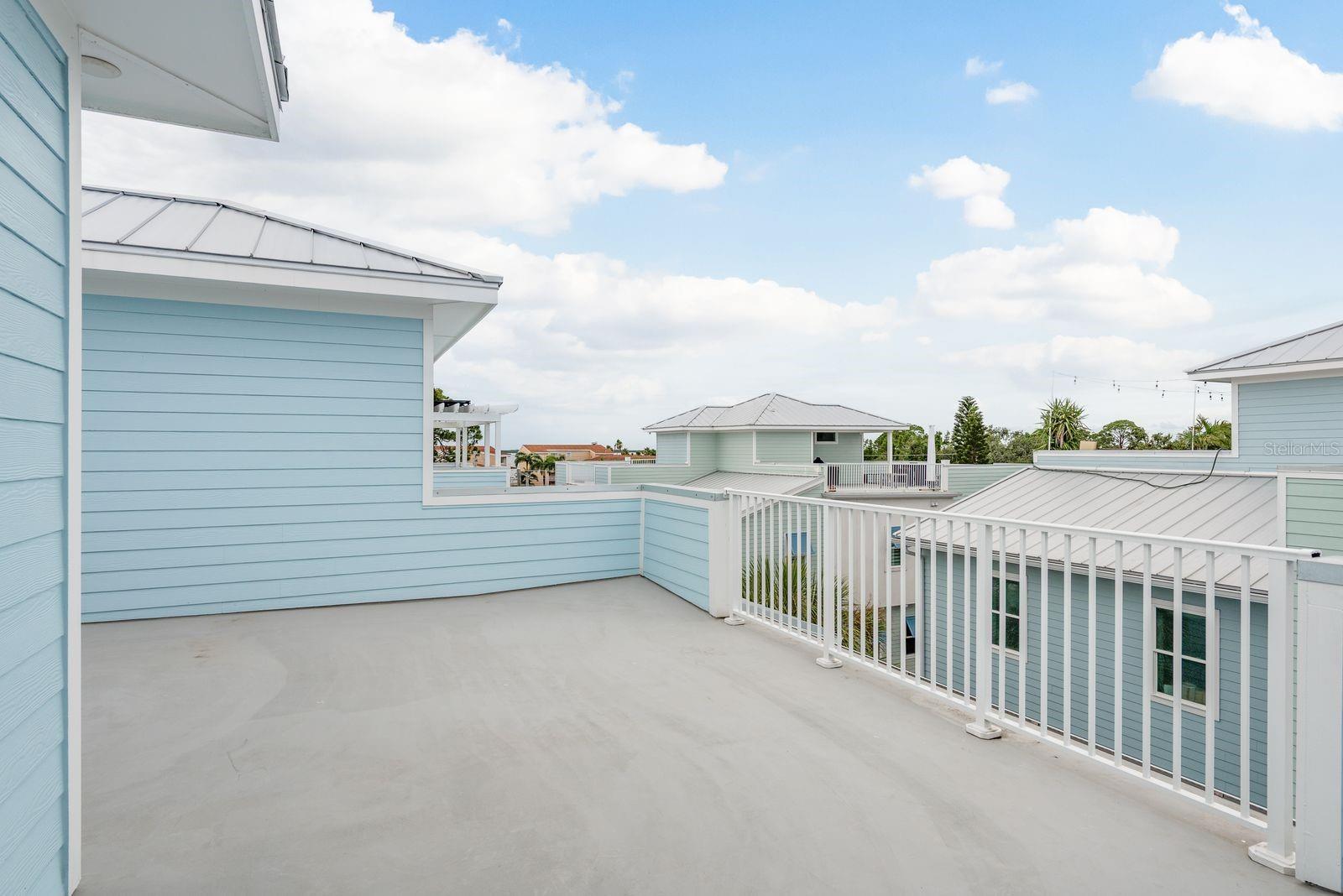 Rooftop terrace with partial water views