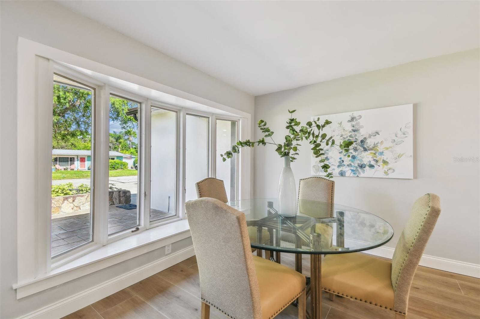 The elegant dining area has a room with a view with these beautiful bay windows.
