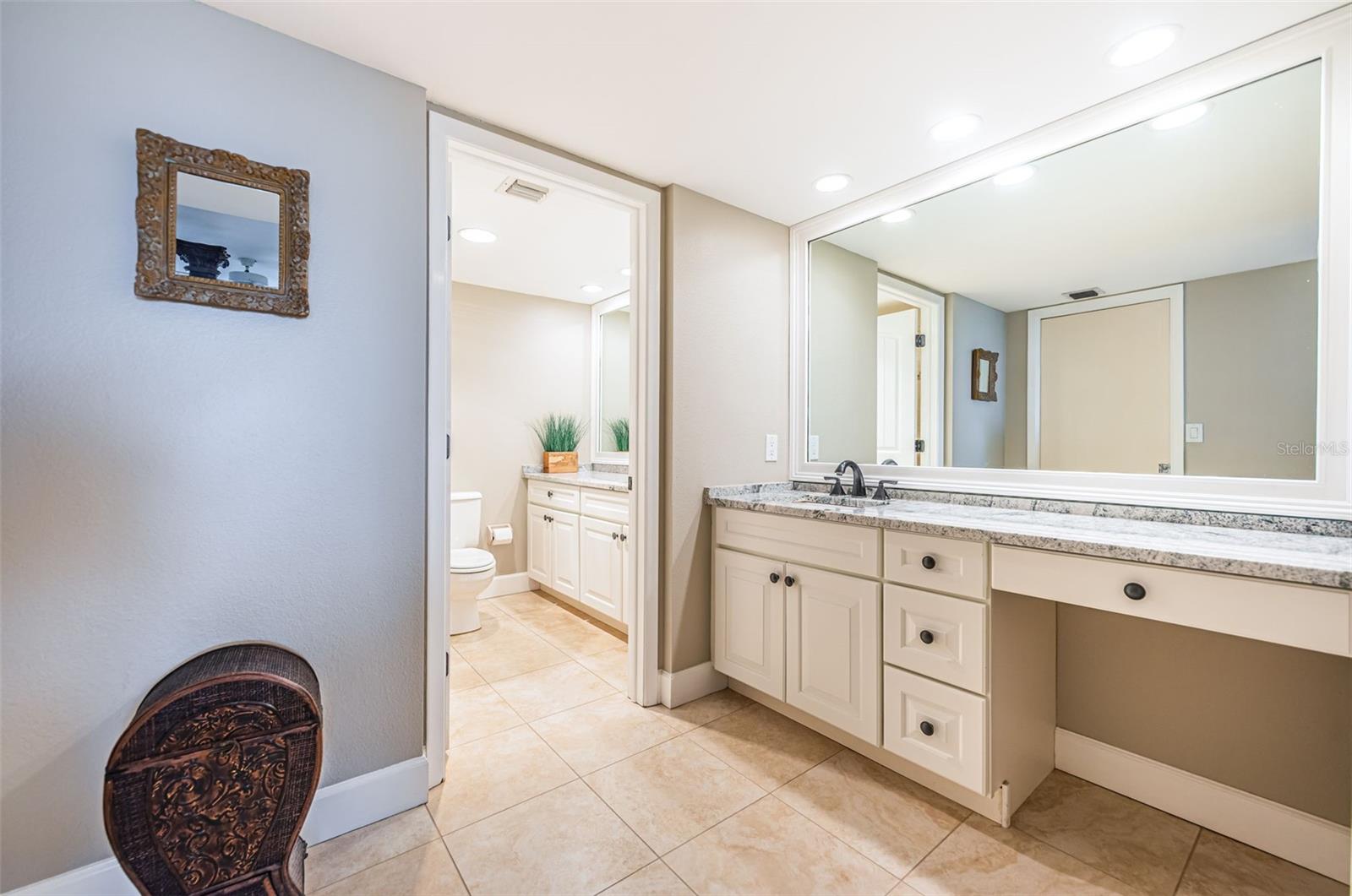 Primary bathroom; note separate dual sinks and a vanity area