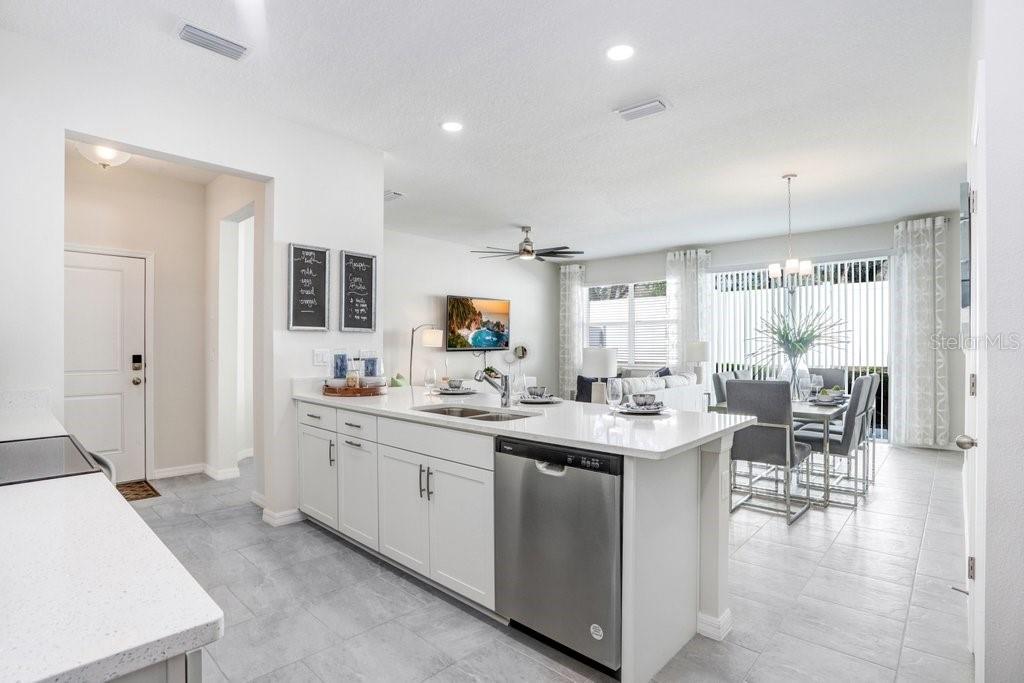 Kitchen includes Stove, Microwave, Dishwasher, Disposal (photo of model home)