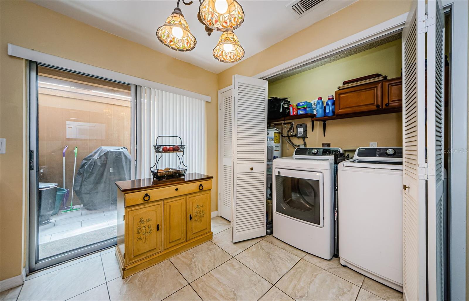 Laundry with built in shelves - sliding glass door to private lanai