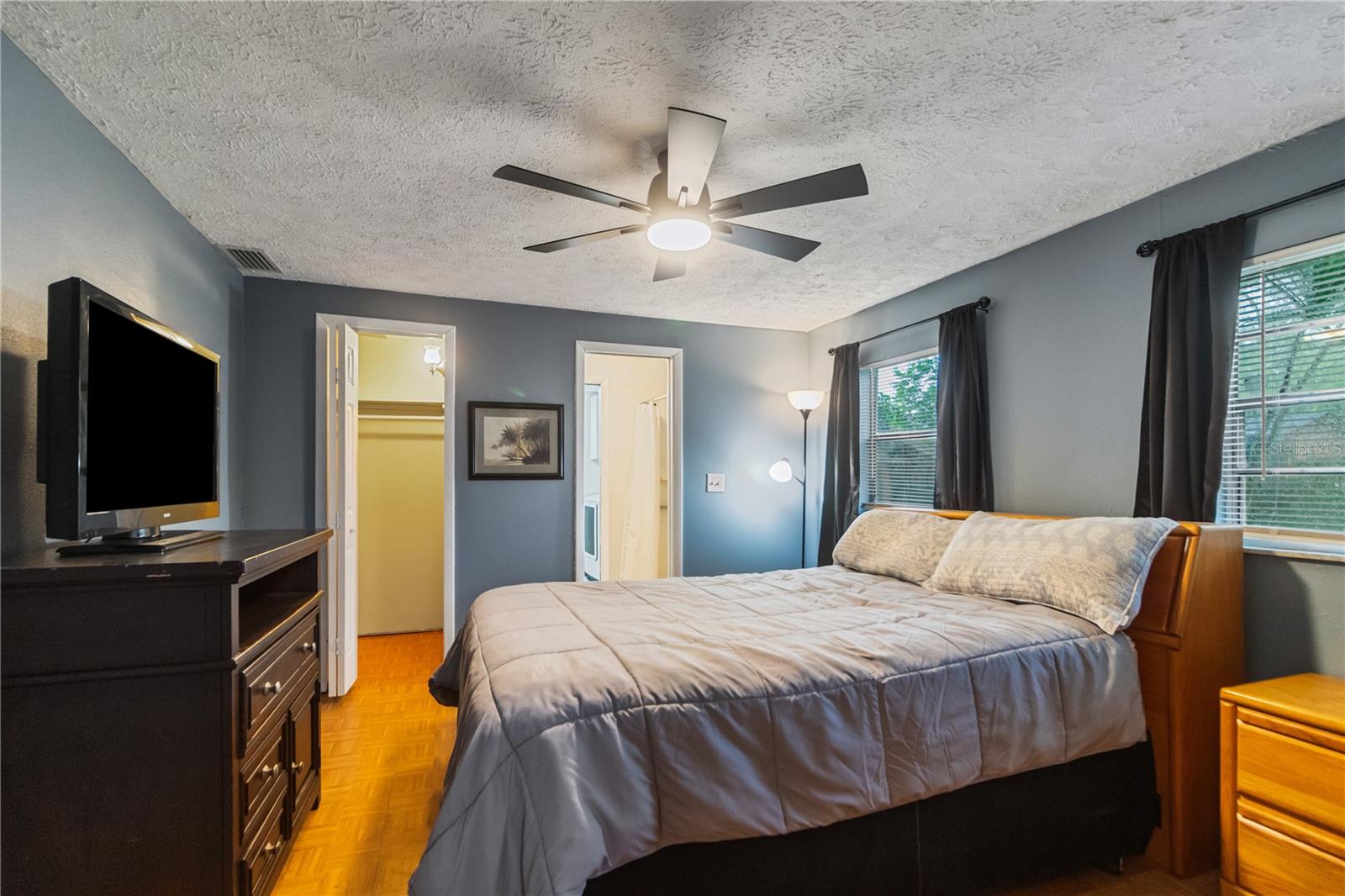 Primary bedroom with walk-in closet and new remote controlled fan/light combo