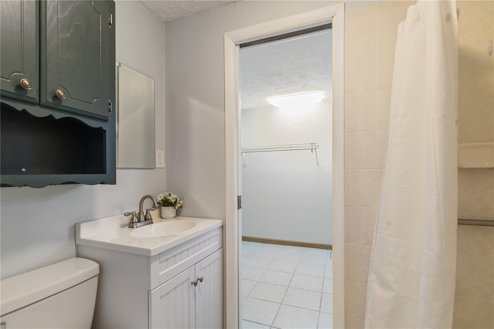 Primary bathroom (shower) with trendy flooring