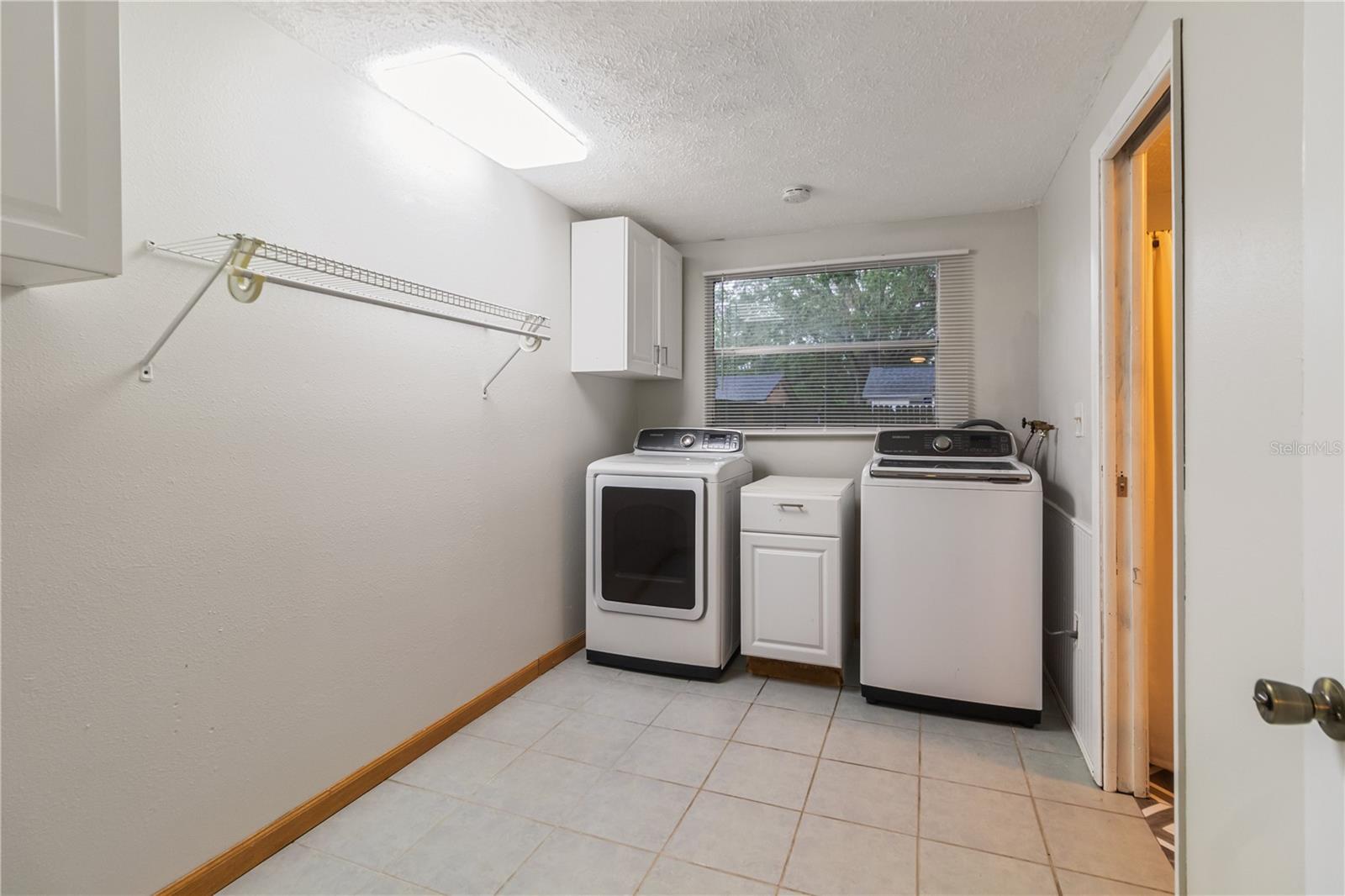 Enclosed large laundry room with washer and dryer included