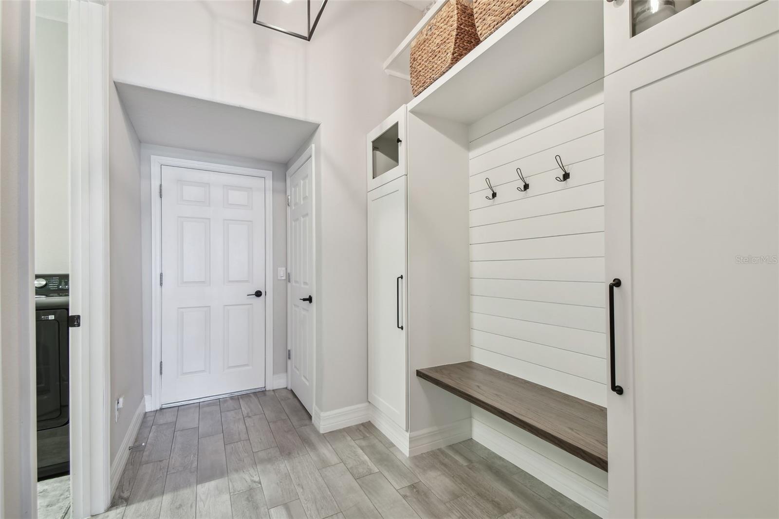 Mud Room with Custom built in cabinets, shelving and bench
