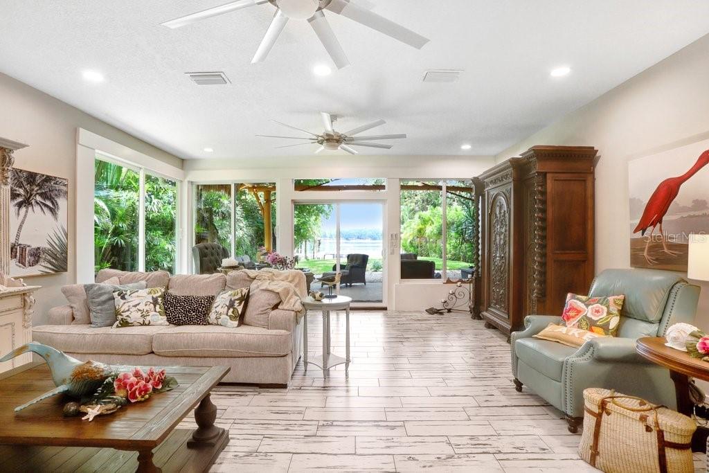 Living Room with Large Windows and Slider Opening to Backyard Oasis