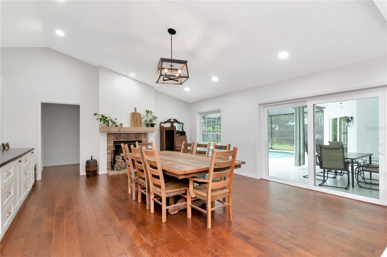 Large Family Room - Currently used for Diningroom with Built Ins and Wood Burning Fireplace with Lanai/Pool Access