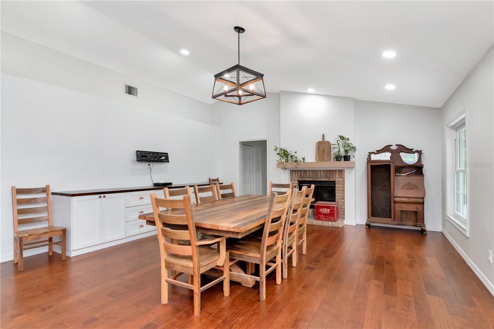 Large Family Room - Currently used for Diningroom with Built Ins and Wood Burning Fireplace with Lanai/Pool Access