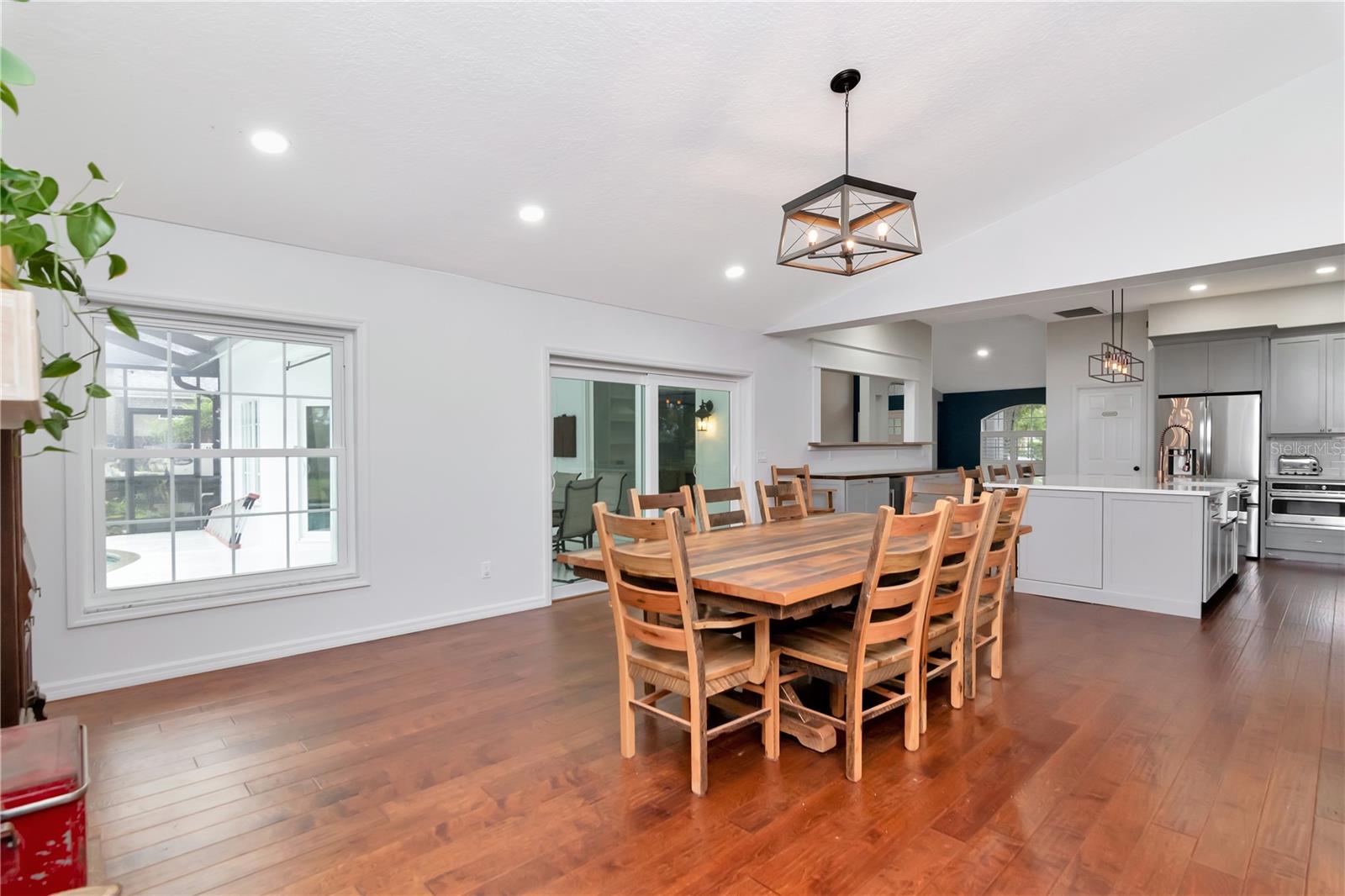 Large Family Room - Currently used for Diningroom with Built Ins and Wood Burning Fireplace with Lanai/Pool Access