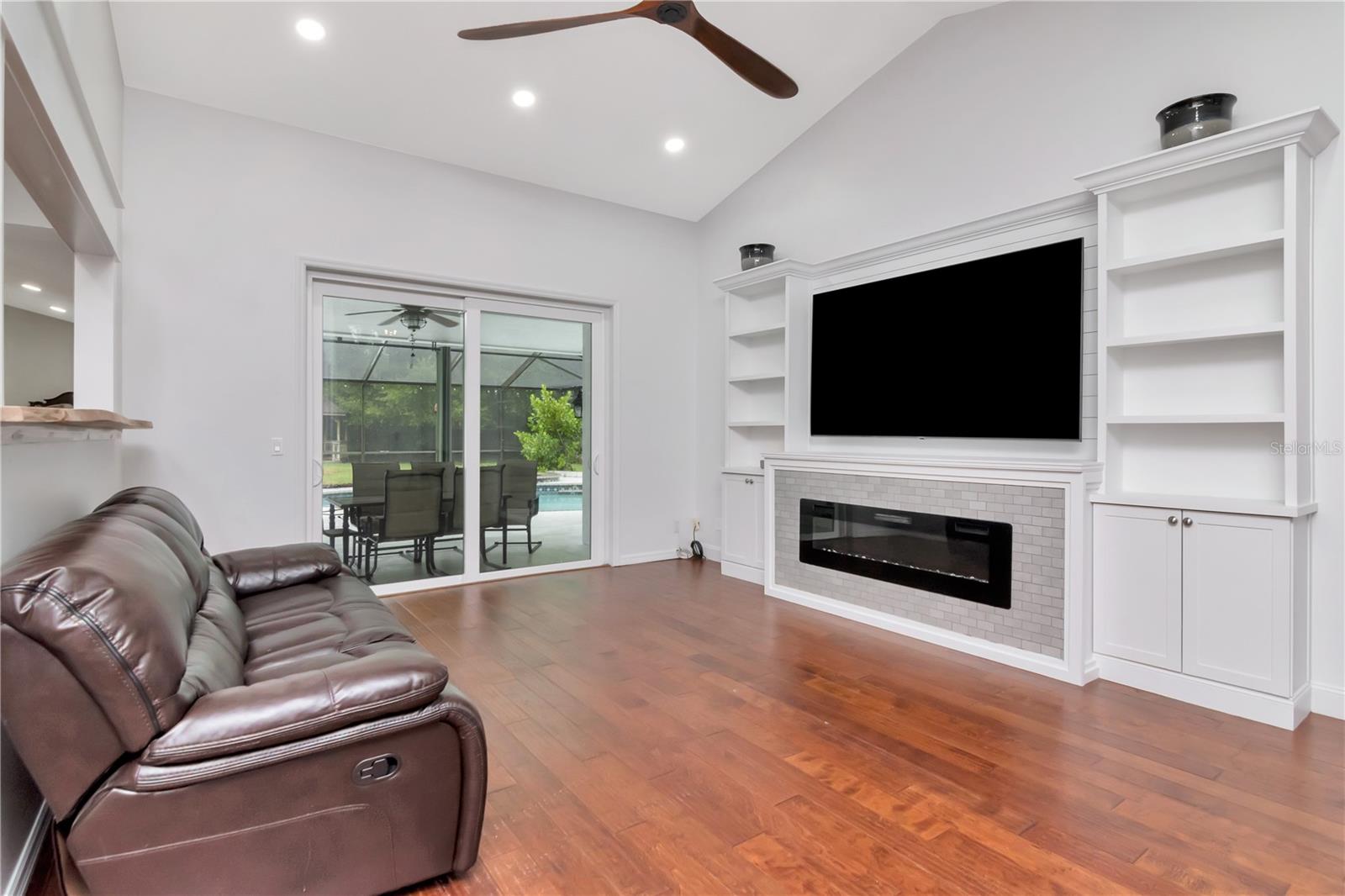 Livingroom with Custom Built Ins and Lanai Access